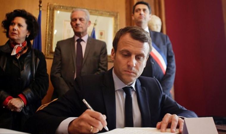 France's President Macron signs controversial pension reforms into law
