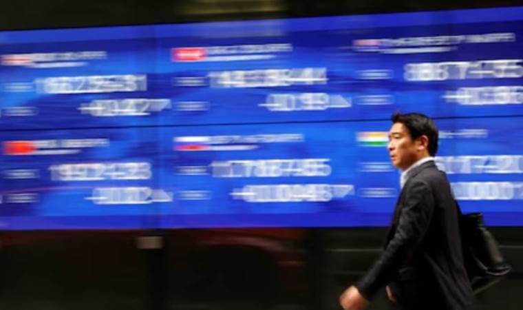 Asian markets wobble amid yuan and US policy uncertainty