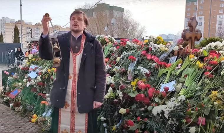 Priest who prayed at Navalny's grave suspended
