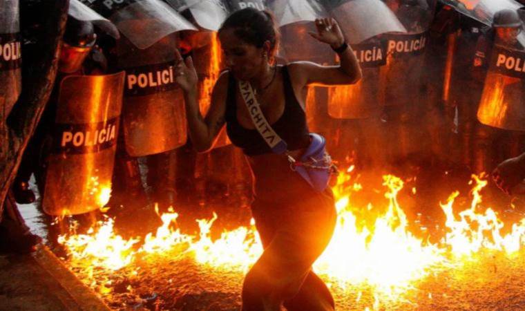 Statues toppled, police stations burned: unrest escalates in Venezuela